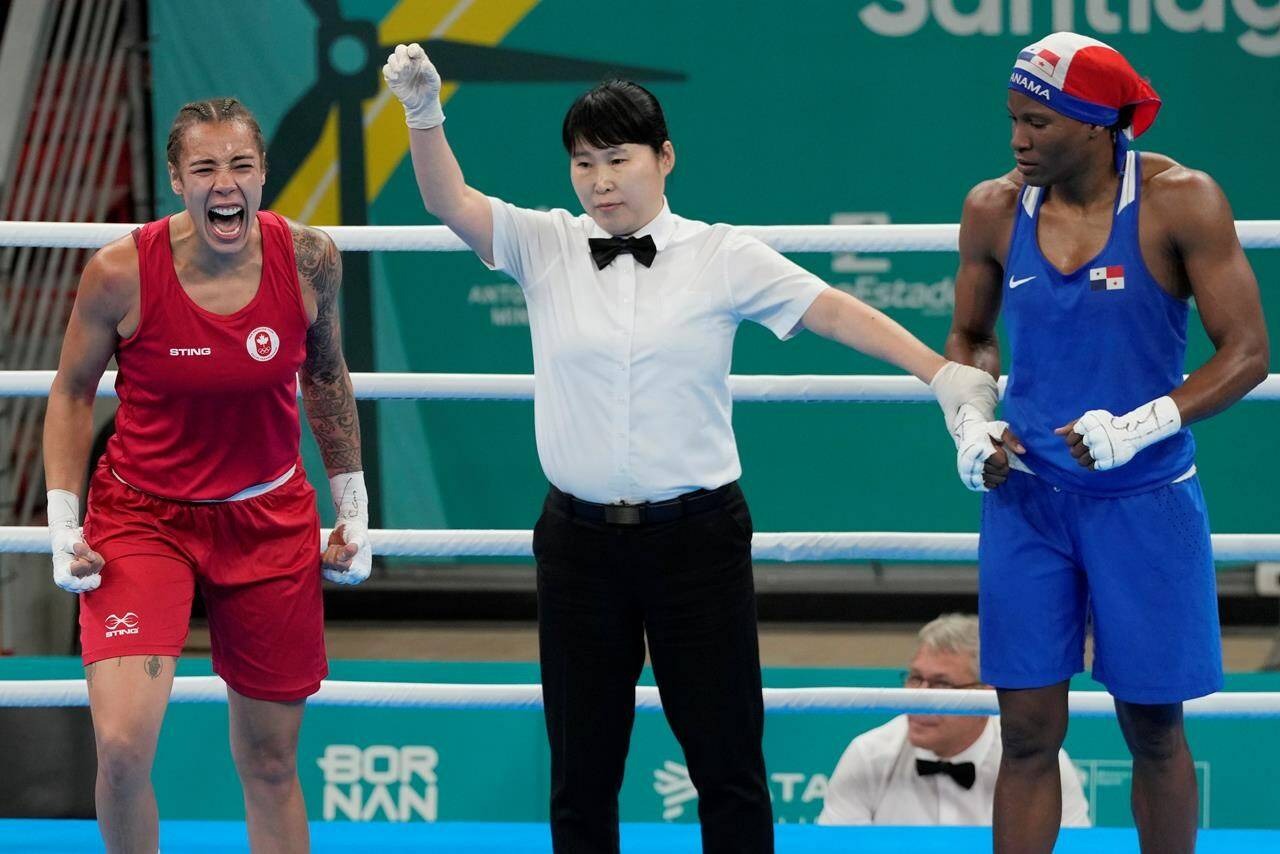 Canadian boxer Tammara Thibeault, left, celebrates her victory over Panama’s Atheyna Bylon after their middleweight gold medal bout at the Pan Am Games in Santiago, Chile on Friday, Oct. 27, 2023. THE CANADIAN PRESS/Frank Gunn