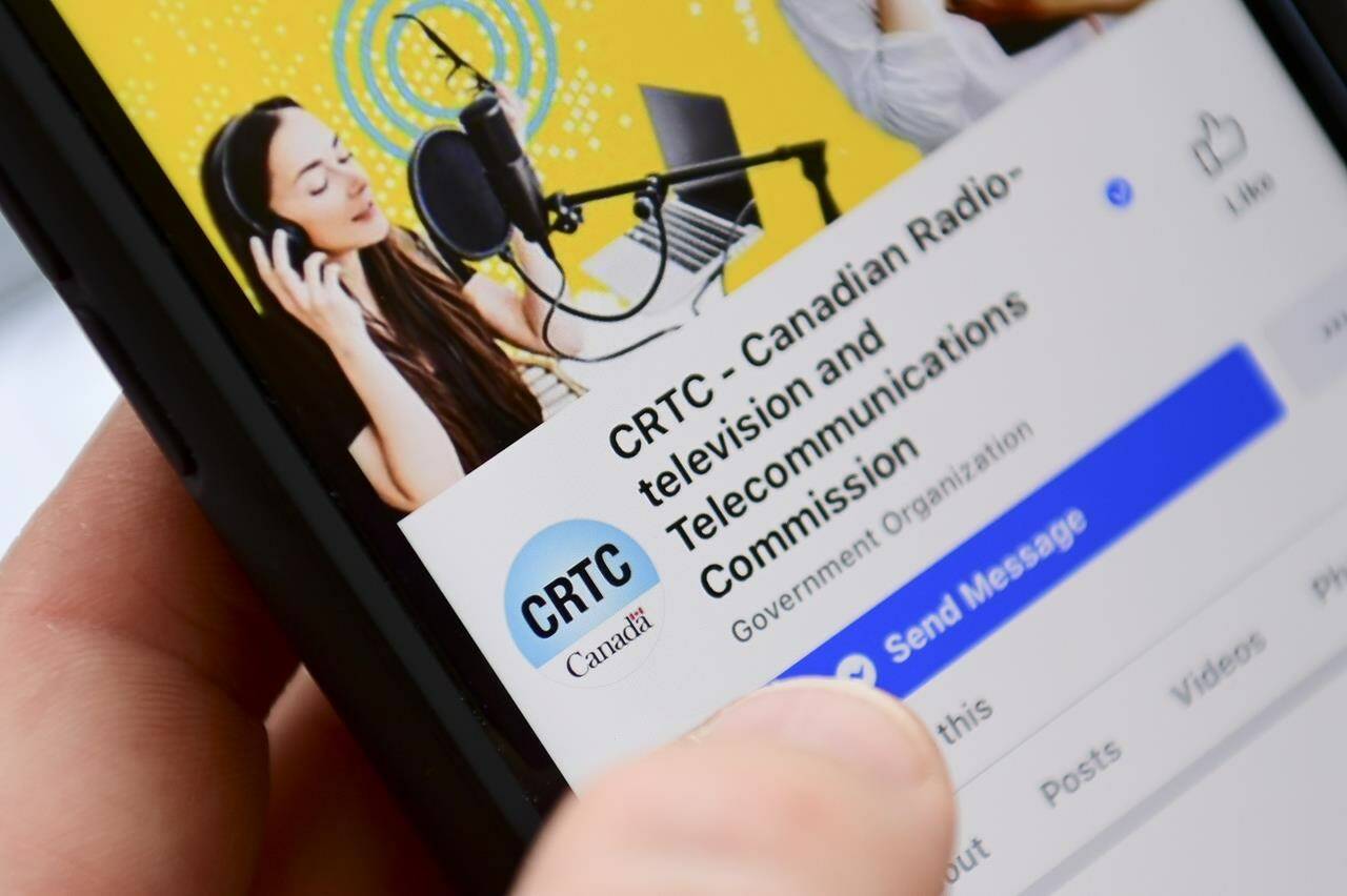 A person navigates to the on-line social-media pages of the Canadian Radio-television and Telecommunications Commission (CRTC) on a cellphone in Ottawa on May 17, 2021. THE CANADIAN PRESS/Sean Kilpatrick