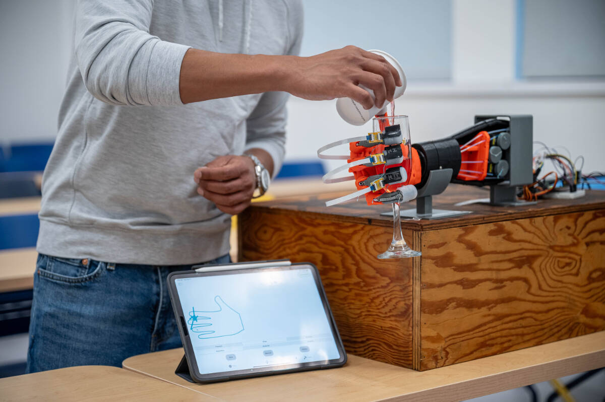 A robotic hand with UBC-developed sensor skin on its fingertips is capable of grasping delicate items, such as a champagne flute, without breaking them. (UBC/Paul Joseph)