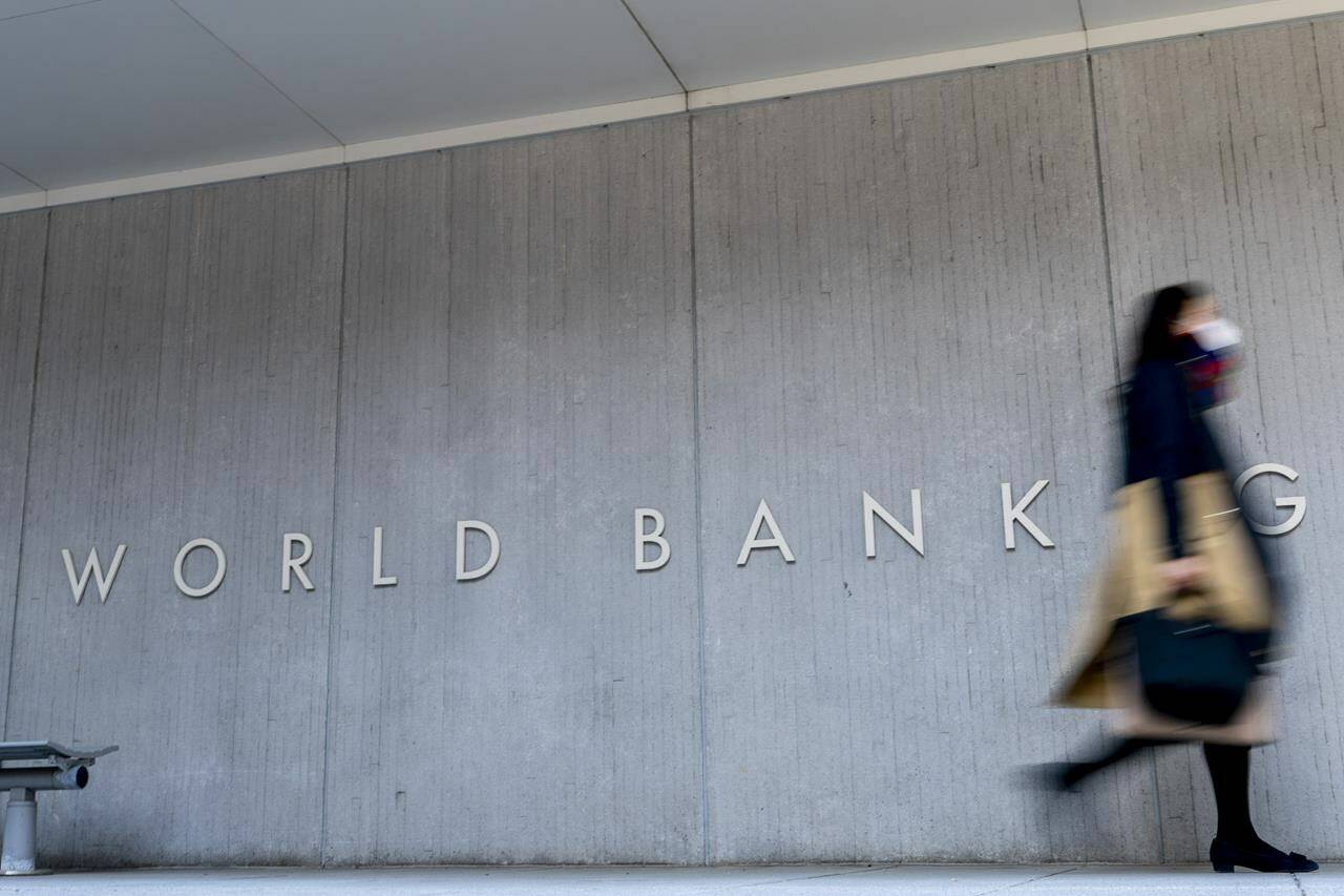 FILE - The World Bank building in Washington, Monday, April 5, 2021. The World Bank says oil prices could be pushed into “uncharted waters” if the violence between Israel and Hamas were to escalate. The organization’s Commodity Markets Outlook finds that the effects on oil prices should be limited if the conflict doesn’t widen. (AP Photo/Andrew Harnik, File)