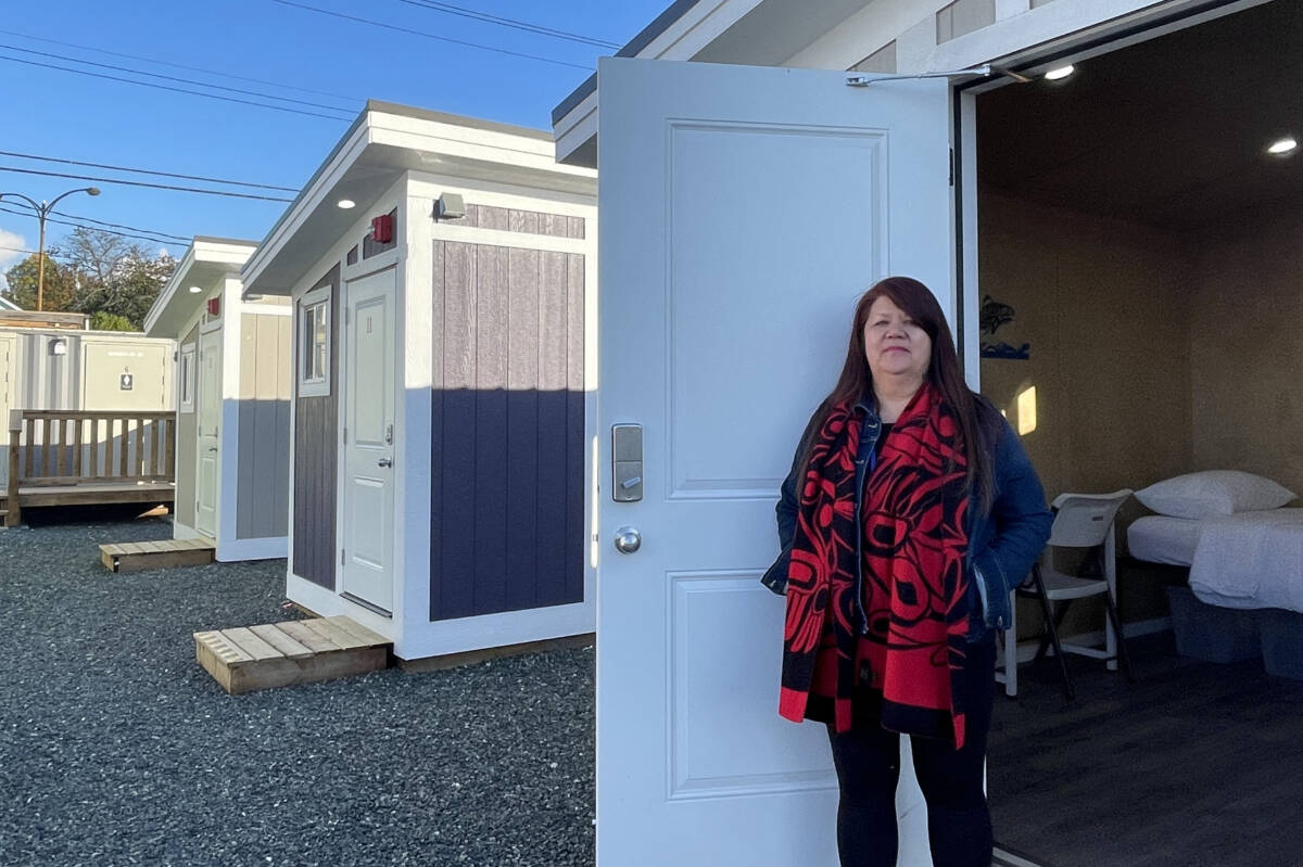 Cyndi Stevens from Port Alberni Friendship Center stands in front of one of 20 housing pods that open to their first residents on Oct. 27, 2023 at Walyaqil Tiny Home Village in Port Alberni. (SUSAN QUINN/ Alberni Valley News)