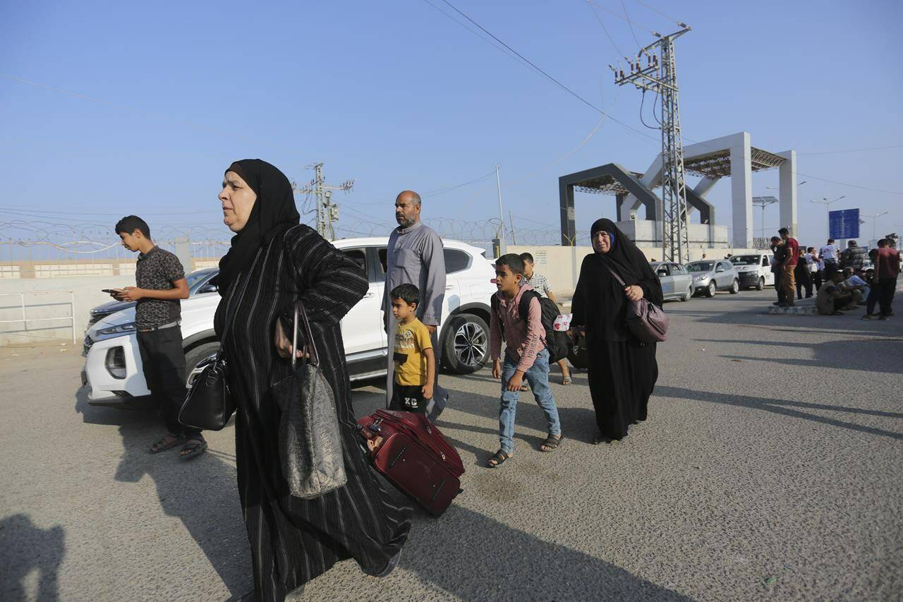 Palestinains wait at the border crossing between Gaza Strip and Egypt in Rafah, Wednesday, Nov. 1, 2023. A Canadian man trying to get out of Gaza with his family says Global Affairs Canada has asked him to gather his documents and be prepared to leave at any moment through the enclave’s border crossing with Egypt. THE CANADIAN PRESS/AP-Hatem Ali