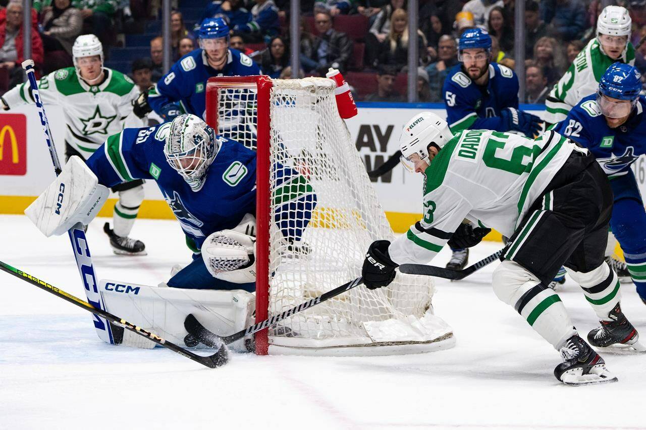 Vancouver Canucks goaltender Thatcher Demko (35) stops Dallas Stars’ Evgenii Dadonov (63) during the first period of an NHL hockey game in Vancouver, on Saturday, Nov. 4, 2023. THE CANADIAN PRESS/Ethan Cairns