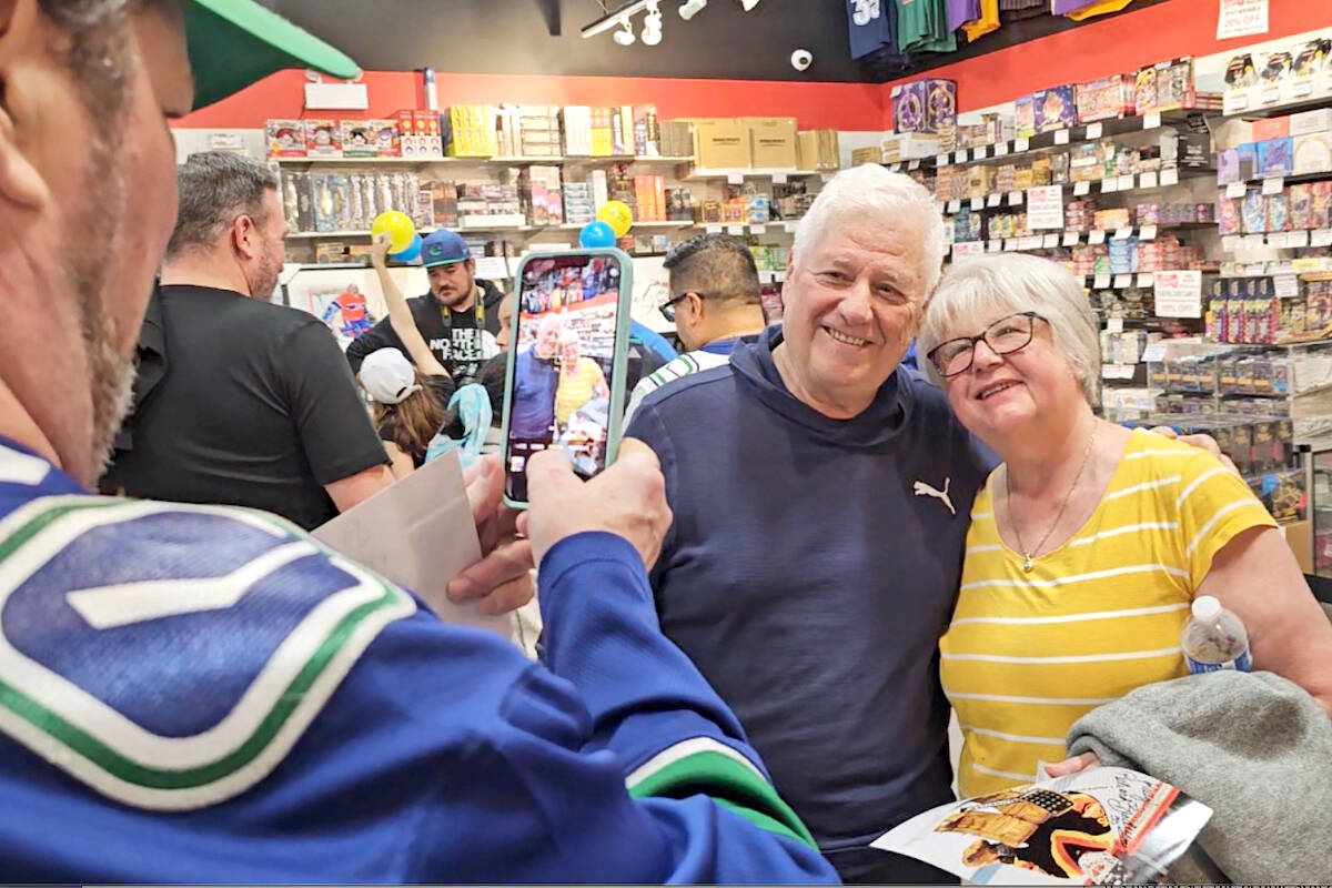 Richard Brodeur posed for a picture with a fan at Langley’s Pastime Sports and Games on Sunday, Nov. 5. (Dan Ferguson/Langley Advance Times)