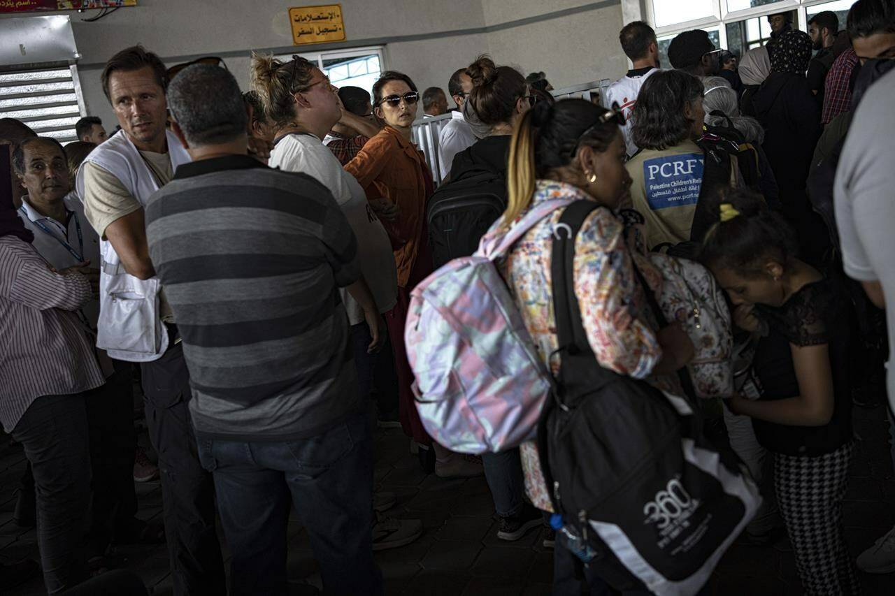 Palestinians and foreign aid workers wait to cross into Egypt at Rafah, Gaza Strip, on Wednesday, Nov. 1, 2023. THE CANADIAN PRESS/AP, Fatima Shbair