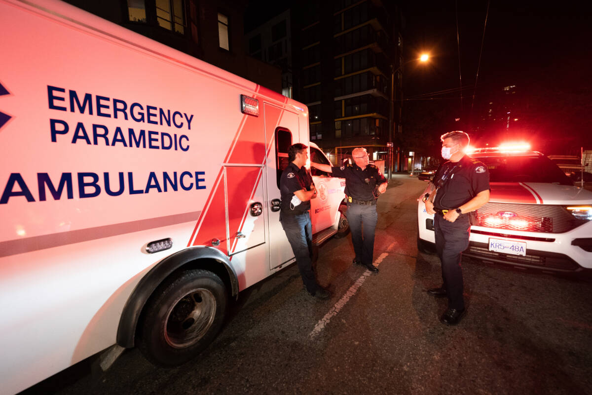 Paramedics debrief after responding to a drug overdose in Vancouver on Wednesday, June 23, 2021. THE CANADIAN PRESS/Jonathan Hayward
