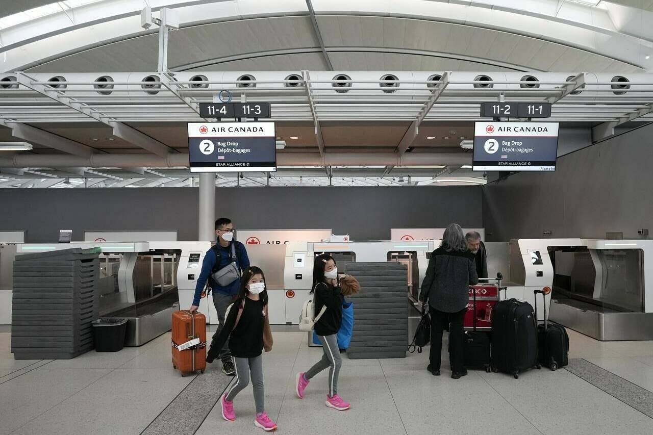People are shown at Pearson International Airport in Toronto on Friday, March 10, 2023. Air Canada CEO Michael Rousseau is apologizing for the airline’s accessibility shortfalls and rolling out new measures to improve the travel experience for hundreds of thousands of passengers living with a disability. THE CANADIAN PRESS/Nathan Denette