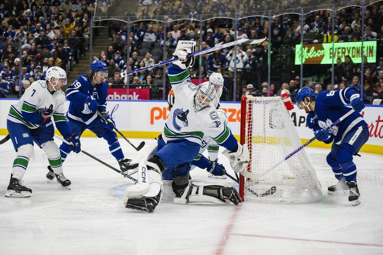 Toronto Maple Leafs right wing William Nylander (right) scores on Vancouver Canucks goaltender Thatcher Demko (35) during second period NHL hockey action, in Toronto on Saturday, Nov. 11, 2023. THE CANADIAN PRESS/Christopher Katsarov