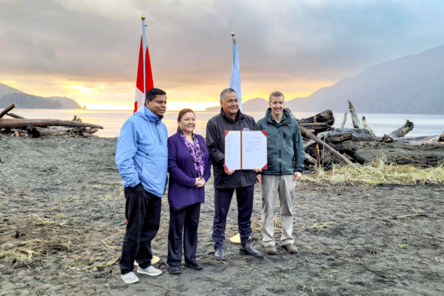 Crown-Indigenous Relations Minister Gary Anandasangaree, left, Ditidaht Chief Councillor Judi Thomas, Pacheedaht Chief Councillor Jeff Jones, and Dave Tovell with Parks Canada sign an agreement to return the use of ?A:?b?e:?s (Middle Beach) to the Pacheedaht First Nation near Port Renfrew. (Courtesy of Parks Canada)