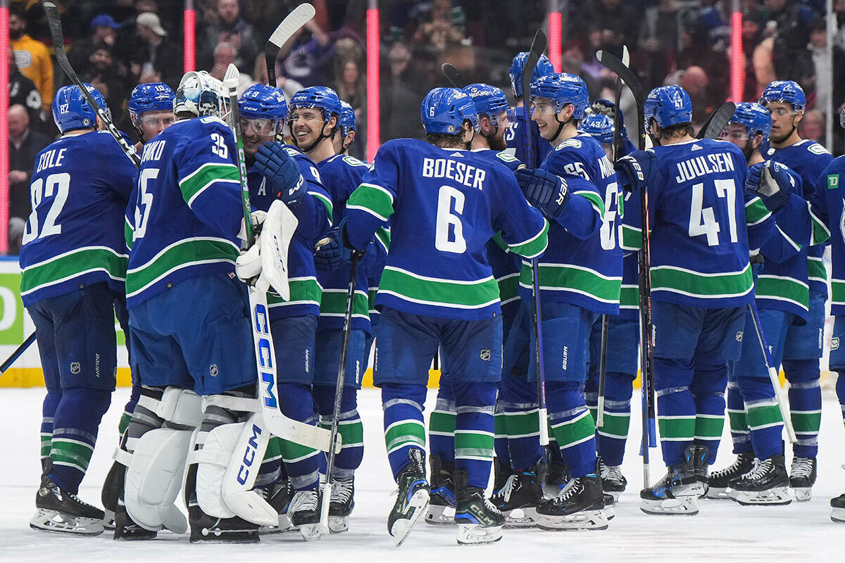 Vancouver Canucks players celebrate after defeating the New York Islanders during overtime of an NHL hockey game in Vancouver, on Wednesday, November 15, 2023. THE CANADIAN PRESS/Darryl Dyck