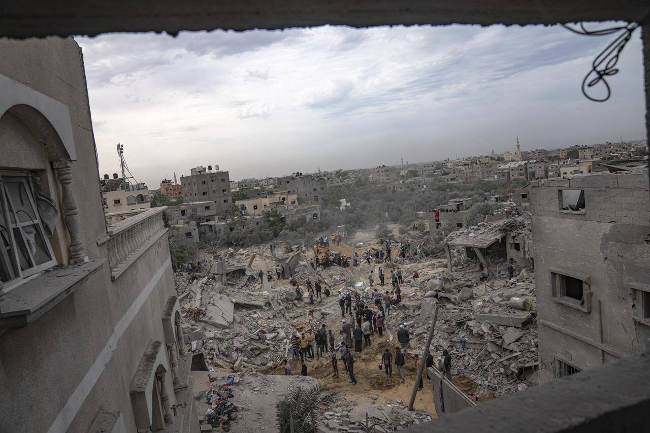Palestinians look for survivors following an Israeli airstrike in Khan Younis, southern Gaza Strip, Sunday, Nov. 12, 2023. A group of 59 B.C. politicians representing local government have signed an open letter to the Canadian government calling for a ceasefire in Gaza. THE CANADIAN PRESS/AP, Fatima Shbair