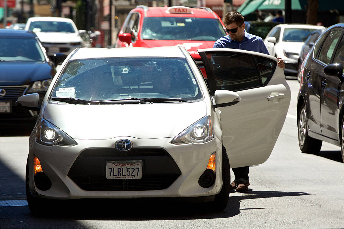 A passenger gets into an Uber rideshare in San Francisco. Labour Minister Harry Bains announced new prosposals to protect ride-hail and food-delivery workers. (Kevin N. Hume/S.F. Examiner)