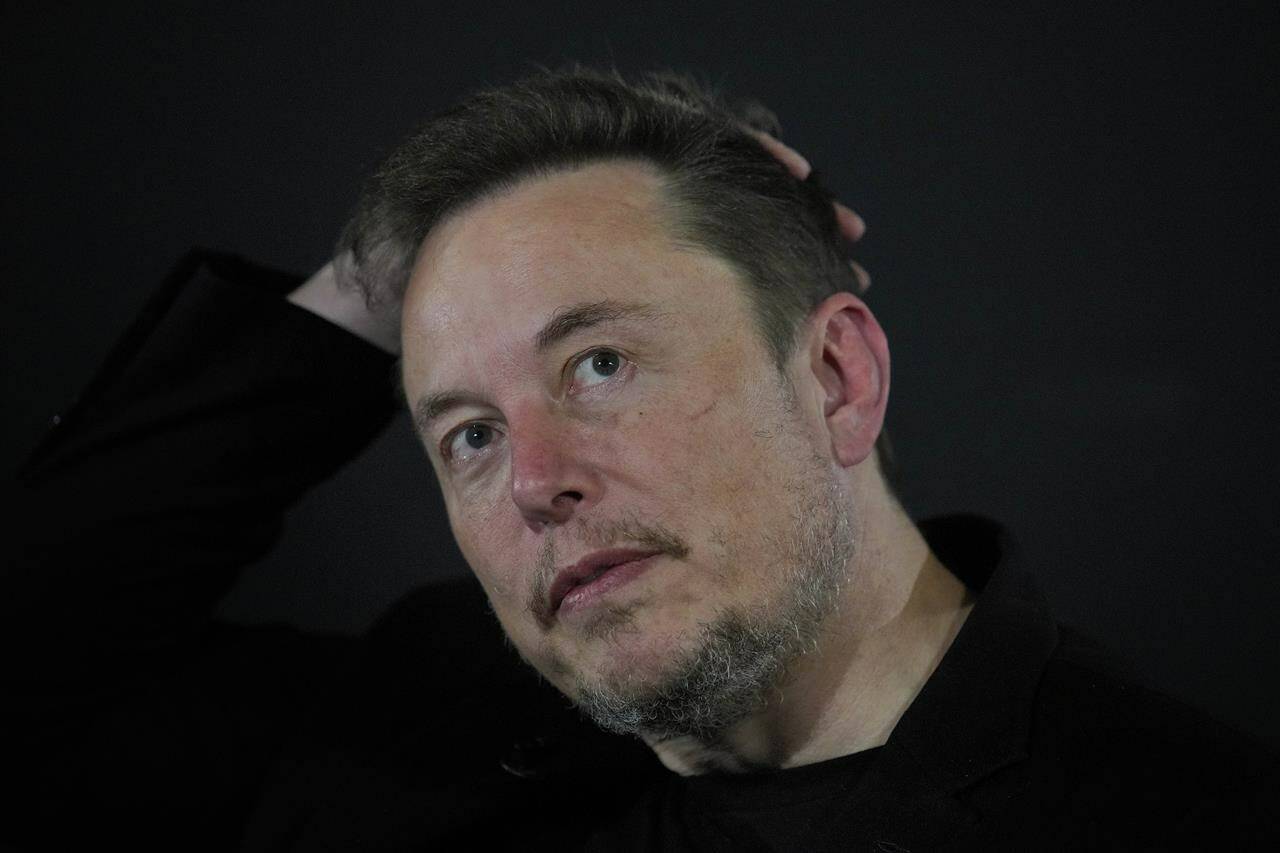FILE - Elon Musk reacts during an in-conversation event with Britain’s Prime Minister Rishi Sunak in London, Thursday, Nov. 2, 2023. IBM has stopped advertising on social media platform X after a report said its ads were appearing alongside material praising Adolf Hitler and Nazis — a fresh setback as the site formerly known as Twitter tries to win back big brands and their ad dollars.(AP Photo/Kirsty Wigglesworth, Pool, File)