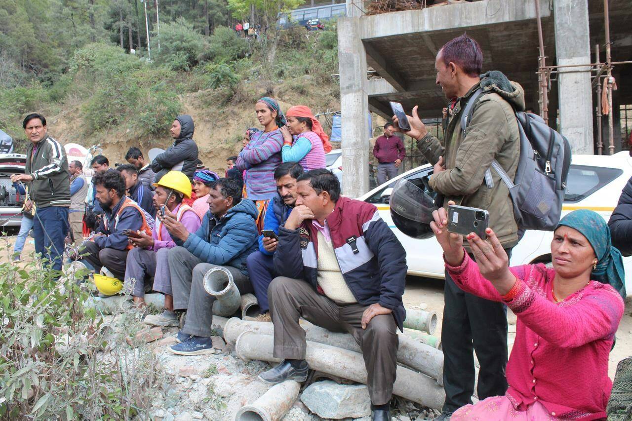People watch rescue operations at the site of an under-construction road tunnel that collapsed in Silkyara in the northern Indian state of Uttarakhand, India, Tuesday, Nov. 29, 2023. Officials in India said Tuesday they were on the verge of rescuing the 41 construction workers trapped in a collapsed mountain tunnel for over two weeks in the country’s north, after rescuers drilled their way through debris to reach them. (AP Photo)