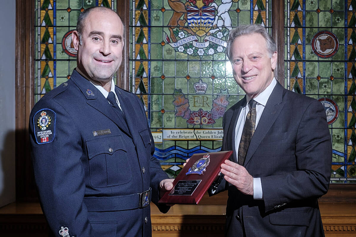 Environment and Climate Change Strategy Minister George Heyman presents Conservation Officer Steve Petrovcic with his award at the BC Legislature in Victoria. Photo: Conservation Officer Service/Facebook