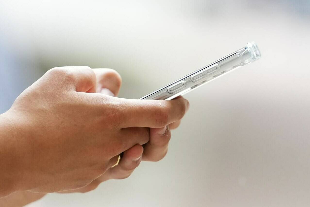 As of Thursday, people having suicidal thoughts or other mental health distress can call or text 988 to reach a trained responder no matter where they live in Canada. A person uses a cellphone in Ottawa on Monday, July 18, 2022.THE CANADIAN PRESS/Sean Kilpatrick