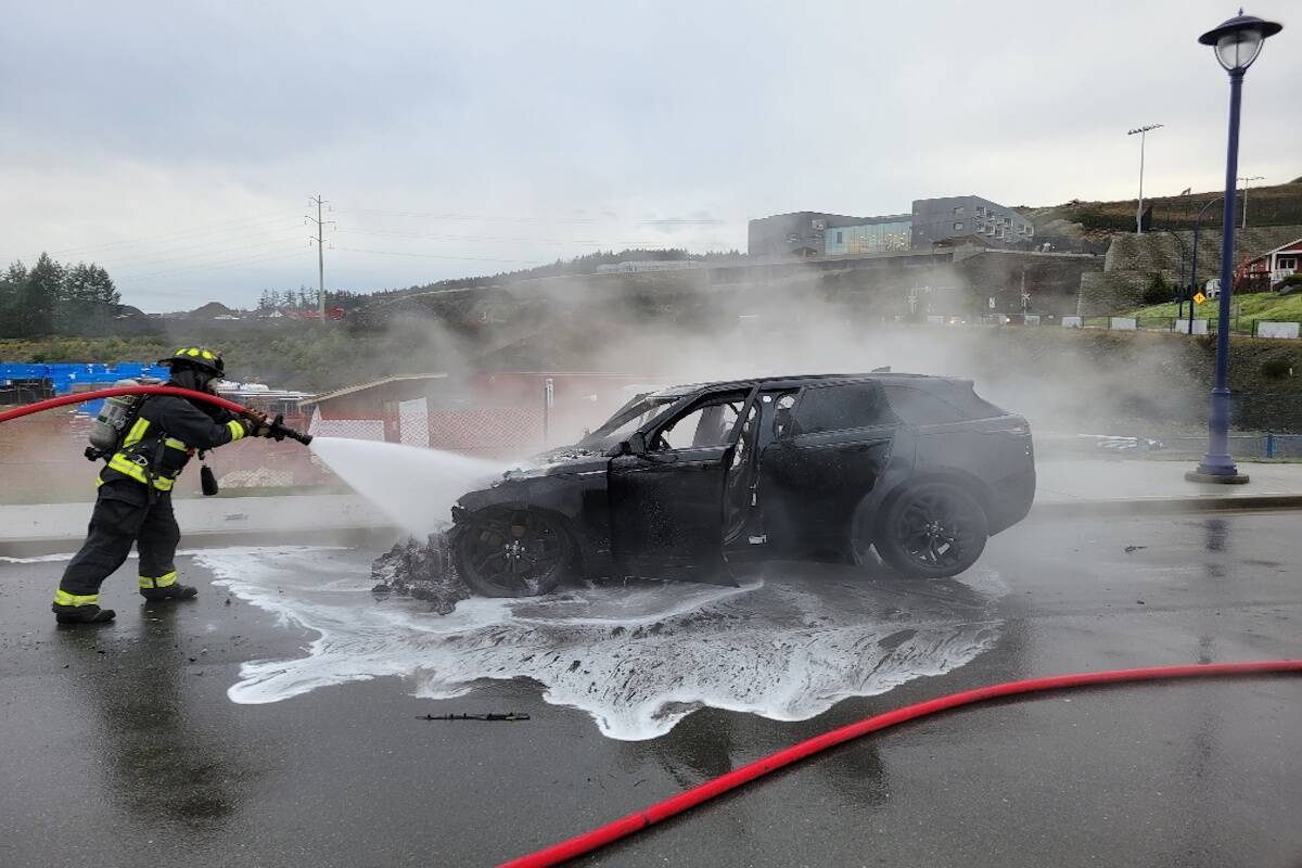 A Langford firefighter douses a vehicle blaze on Dec. 6. (West Shore RCMP)