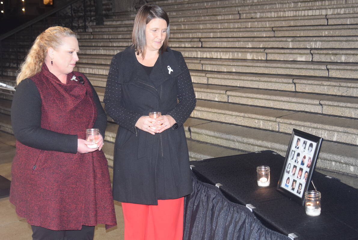 Parliamentary secretary for gender equity Kelli Paddon (left) and Victoria-Beacon Hill MLA Grace Lore (right) speak at a candlelight memorial Wednesday (Dec. 6) at the B.C. legislature. The event was held to commemorate the 14 women killed during the Montreal massacre. (Brendan Mayer/News Staff)