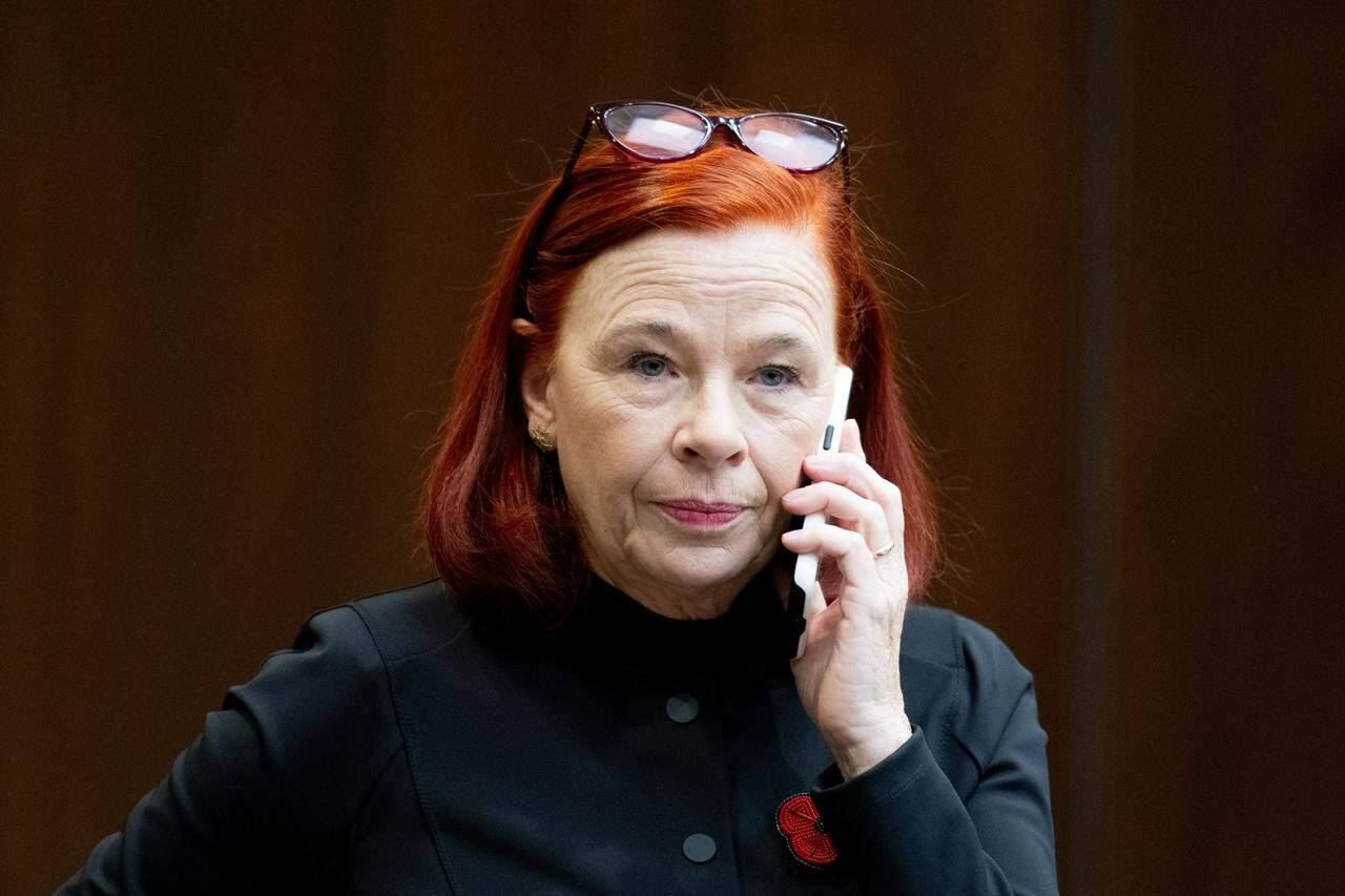 Catherine Tait, President and CEO of the Canadian Broadcasting Corporation (CBC) talks on the phone before appearing at the Standing Committee on Canadian Heritage in Ottawa, on Thursday, Nov. 2, 2023. THE CANADIAN PRESS/Spencer Colby