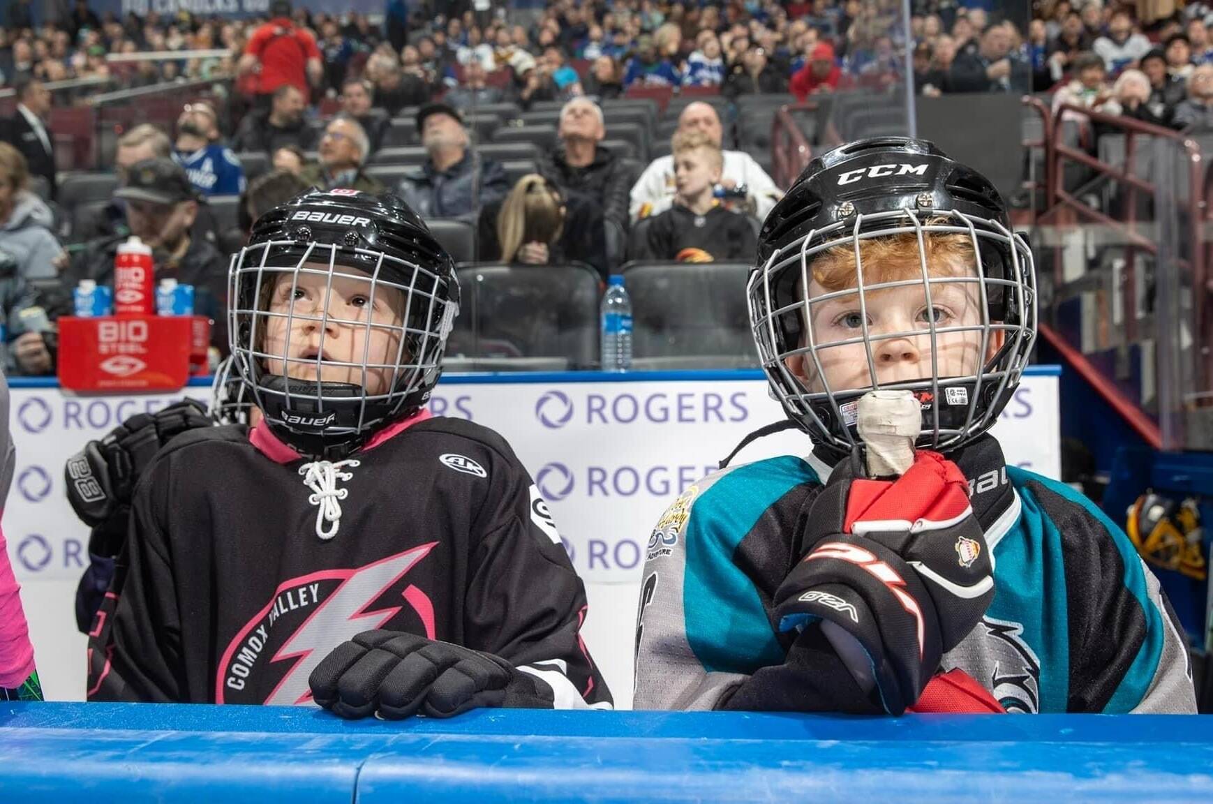 Port Hardy Hawks player Weston Ireton (right) watches the Vancouver Canucks and the Anaheim Ducks from the bench. (Vancouver Canucks Facebook photo)