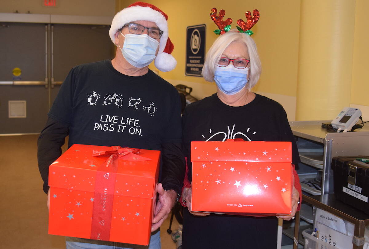 Steve Farmer (left) and Kathy Green (right) deliver boxes of popcorn to health-care professionals at Victoria General Hospital on Friday (Dec. 8). (Brendan Mayer/News Staff)