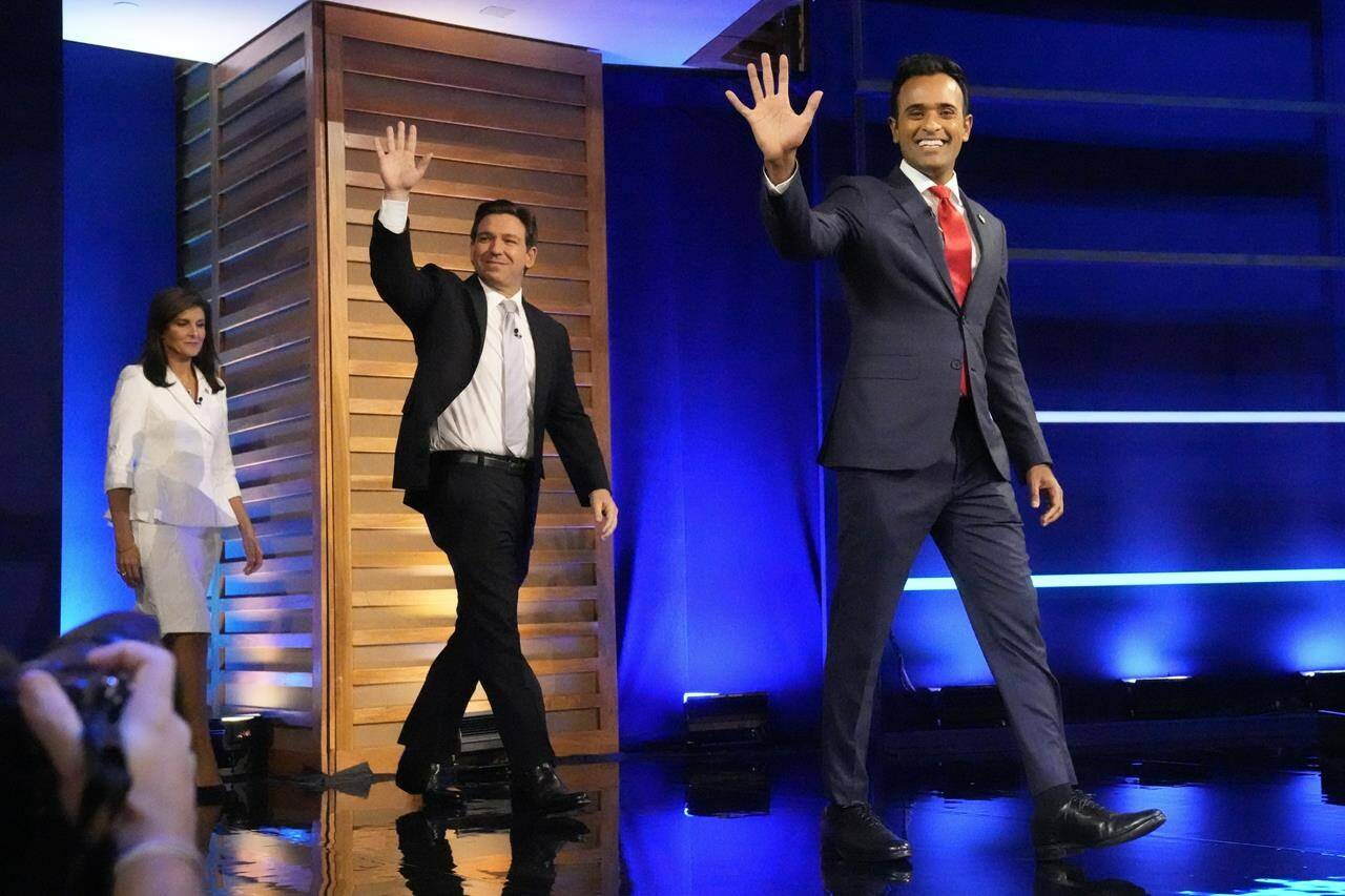 FILE - Republican presidential candidates from left, former UN Ambassador Nikki Haley, Florida Gov. Ron DeSantis, and businessman Vivek Ramaswamy arrive on stage before a Republican presidential primary debate hosted by NBC News Wednesday, Nov. 8, 2023, at the Adrienne Arsht Center for the Performing Arts of Miami-Dade County in Miami. Republican presidential candidates will cross paths again in Iowa just days after a fractious debate and as the countdown to the caucuses nears the one-month mark. DeSantis, Haley and Ramaswamy will make their case in northwest Iowa, a more rural, conservative corner of the state. (AP Photo/Wilfredo Lee, File)