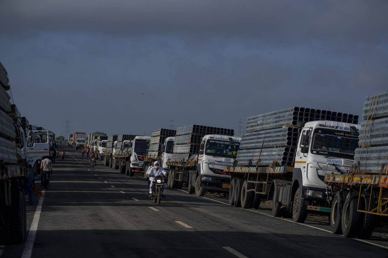 FILE - Trucks carry aluminum alloy frames to Adani Green Energy Limited’s Renewable Energy Park near Khavda, Bhuj district near the India-Pakistan border in the western state of Gujarat, India, Sept. 21, 2023. (AP Photo/Rafiq Maqbool, File)