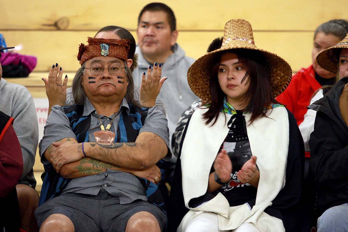Maxwell Johnson and his granddaughter Tori-Anne Tweedie look on during the uplifting ceremony for Johnson and his family at the Big House in Bella Bella, B.C., on October 24, 2022. The day was meant to be an apology ceremony for the two, but that was cancelled after two Vancouver Police Department officers never showed up. THE CANADIAN PRESS/Chad Hipolito