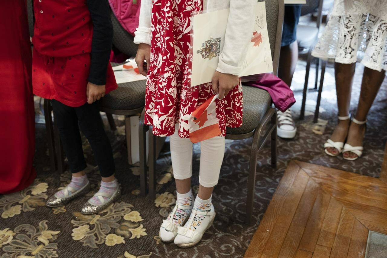 Canada’s population grew by more than 430,000 during the third quarter, marking the fastest pace of population growth in any quarter since 1957. Children stand to sing O Canada after being sworn-in as Canadian citizens at the Halifax Citadel in Halifax on Wednesday, May 24, 2023. THE CANADIAN PRESS/Darren Calabrese