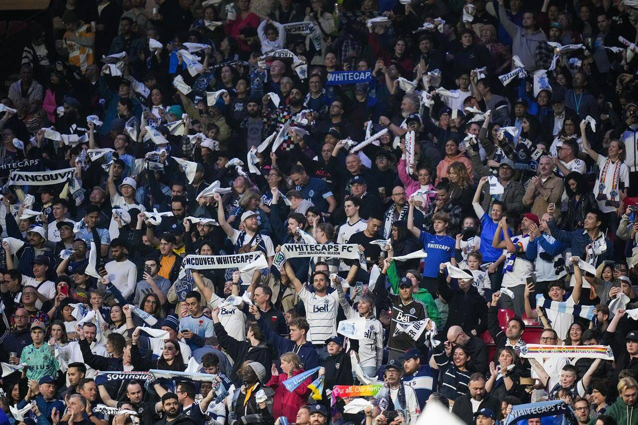 Vancouver Whitecaps fans cheer as the team walks onto the field before Game 2 of a first-round MLS playoff soccer match against Los Angeles FC, in Vancouver, on Sunday, November 5, 2023. The Whitecaps are shifting their first-round CONCACAF Champions Cup game on Feb. 7 to Starlight Stadium in Langford, B.C., because of a scheduling conflict at B.C. Place, the club’s home stadium. THE CANADIAN PRESS/Darryl Dyck
