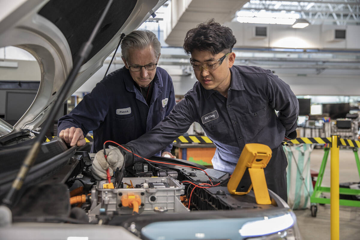 Patrick Jones, an instructor of Camosun College’s automotive technician program, advises a student of the school’s electric vehicle micro-credential course. (Courtesy of Camosun College)