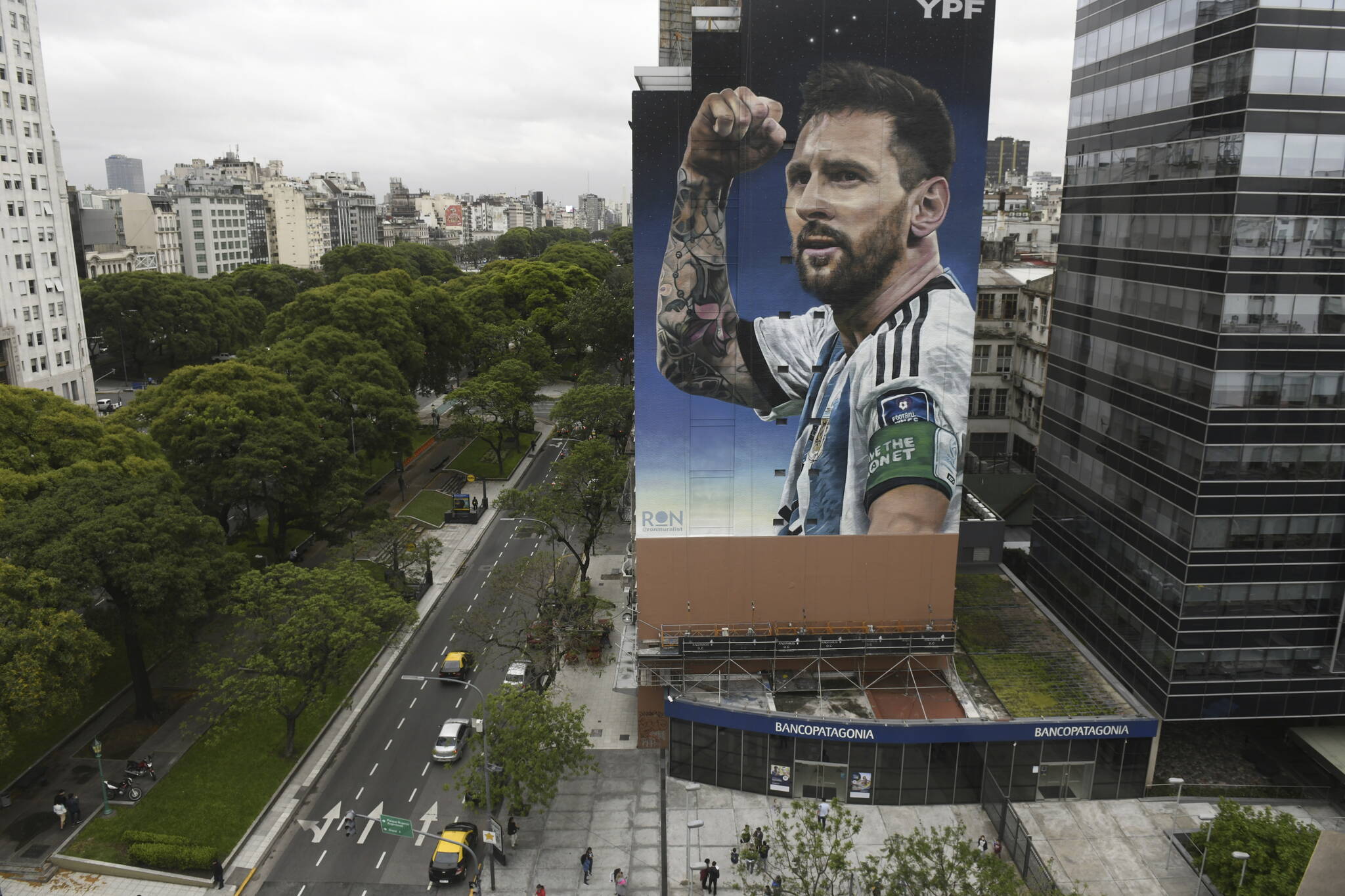 A new mural of soccer player Lionel Messi is unveiled in downtown Buenos Aires, Argentina, Monday, Dec. 18, 2023, one year after his national Argentine team won the World Cup tournament. (AP Photo/Gustavo Garello)
