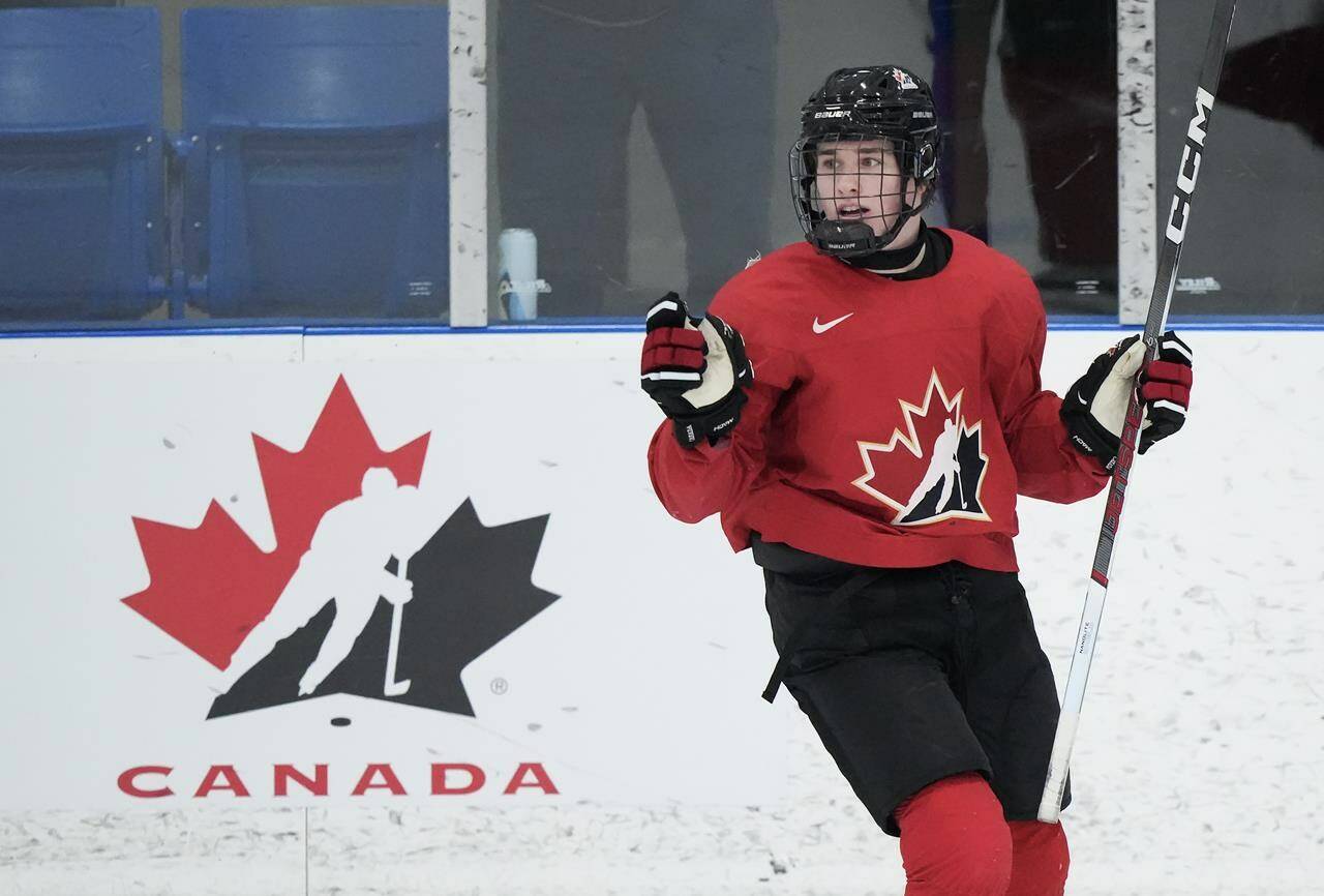 Canada forward Macklin Celebrini celebrate his goal against the U Sports all-stars during first period Canadian World Juniors selection camp hockey action in Oakville, Ont., on Wednesday, Dec. 13, 2023. Celebrini was contemplating his next hockey stop. The teenage star poised to join the U.S. college hockey ranks for the 2023-24 season had plenty of NCAA schools pining for his services back in June 2022. THE CANADIAN PRESS/Nathan Denette