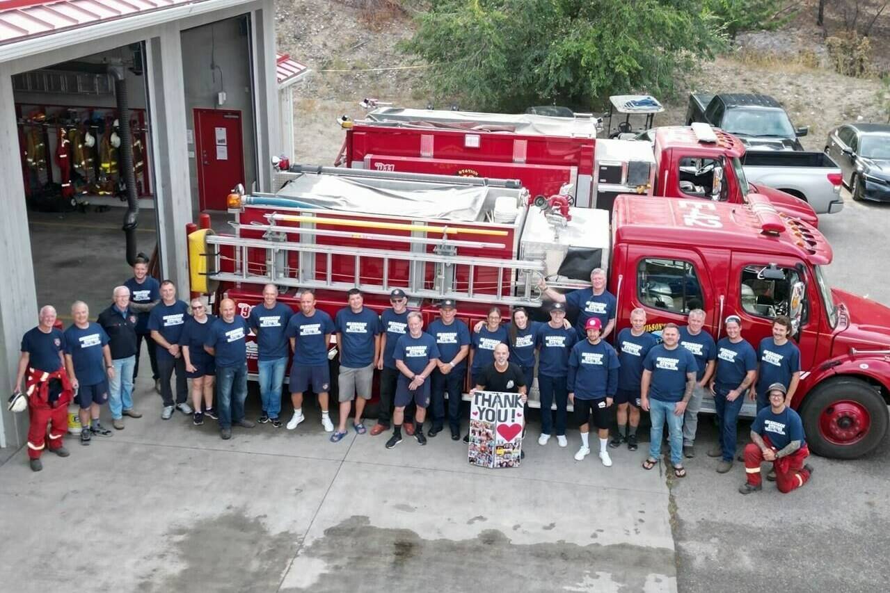 Members of the Wilson’s Landing, B.C., Fire Department pose for a group photo in a September 2023, handout image, about three weeks after a fast-moving wildfire swept through their small community on the shores of Okanagan Lake, near West Kelowna, B.C. THE CANADIAN PRESS/HO-Lt. Frank McKenzie