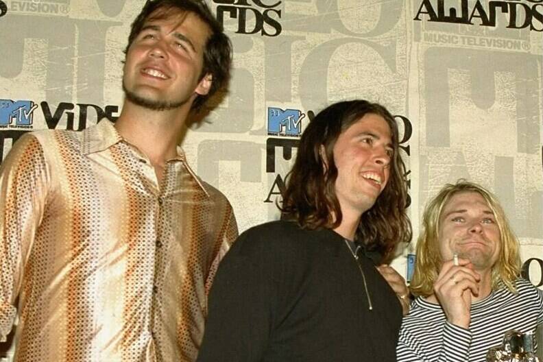 FILE - Nirvana band members Krist Novoselic, from left, Dave Grohl and Kurt Cobain pose after receiving the award for best alternative video for “In Bloom” at the 10th annual MTV Video Music Awards on Sept. 2, 1993, in Universal City, Calif. A federal appeals court has revived a child sexual exploitation lawsuit filed by the man who appeared naked as a 4-month-old infant on the 1991 cover of Nirvana’s album “Nevermind.” Spencer Elden’s lawsuit against the grunge rock group was dismissed last year but a the court in California revived it on Thursday and sent it back to a lower court. (AP Photo/Mark J. Terrill, File)