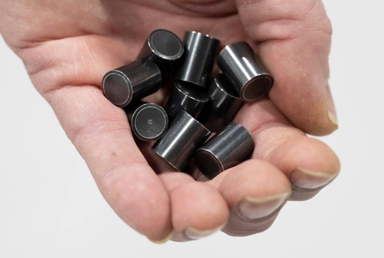 Nuclear Waste Management Organization senior transportation engineer Ulf Stahmer holds enough model uranium pellets to power a house for a year during a tour of NWMO’s facility in Oakville, Ont., on Tuesday, December 12, 2023. THE CANADIAN PRESS/Frank Gunn