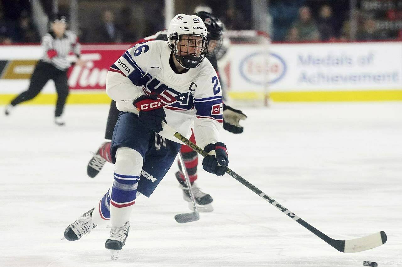 FILE - United States' Kendall Coyne Schofield skates with the puck against Canada during the first period of a Rivalry Series hockey game Nov. 17, 2022, in Kamloops, British Columbia. Coyne Schofield, a three-time Olympian and former U.S. captain, will suit up for Minnesota’s Professional Women's Hockey League opener at Boston on Jan. 3. The game will underline Coyne Schofield’s determination in returning to competitive play, after the birth of her son, now 6 months old. (Jesse Johnston/The Canadian Press via AP, File, File)