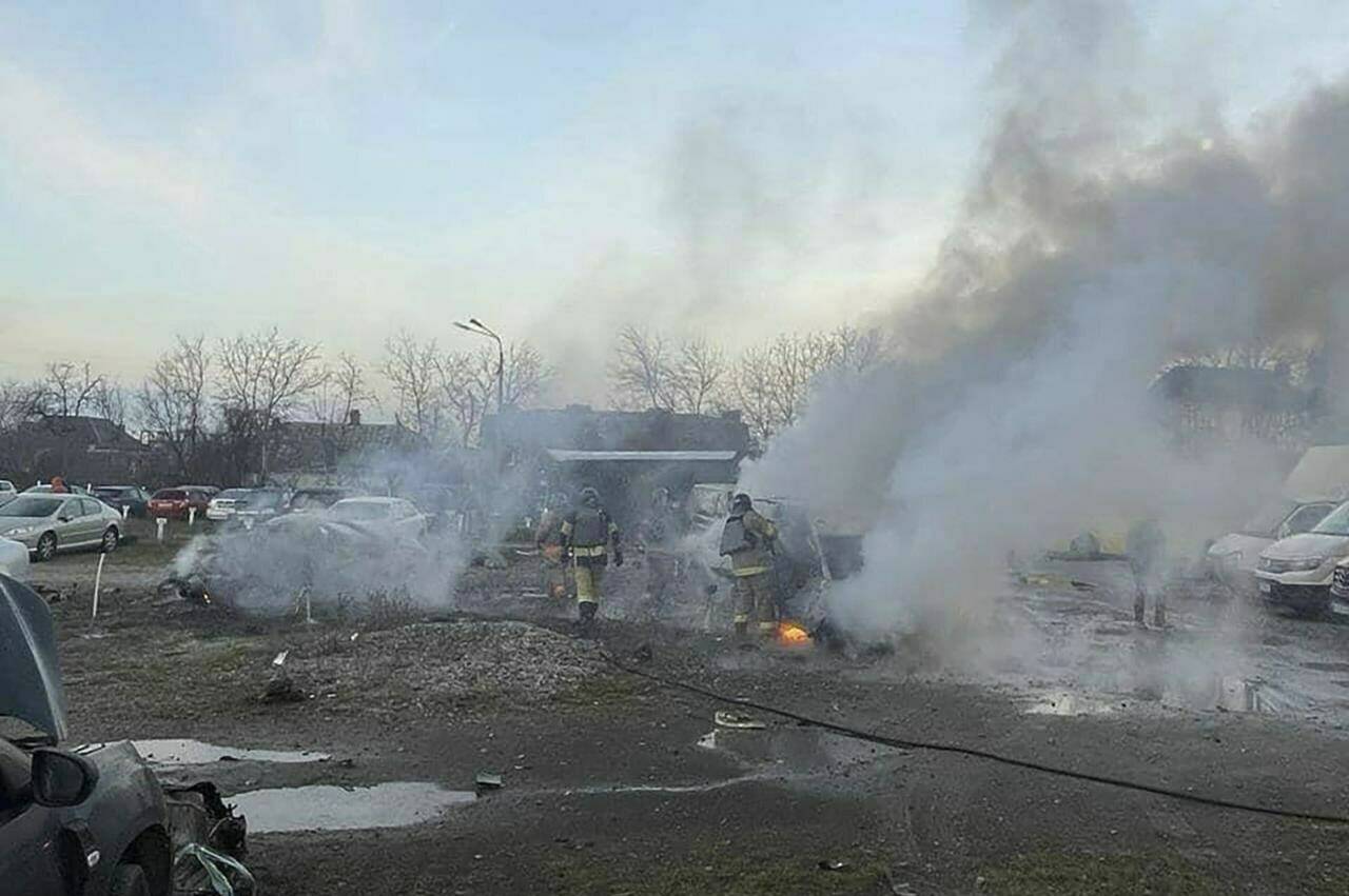 In this photo provided by the Ukrainian Emergency Service, firefighters work to extinguish a fire after a Russian attack in Kyiv, Ukraine, Friday, Dec. 29, 2023. (Ukrainian Emergency Service via AP)