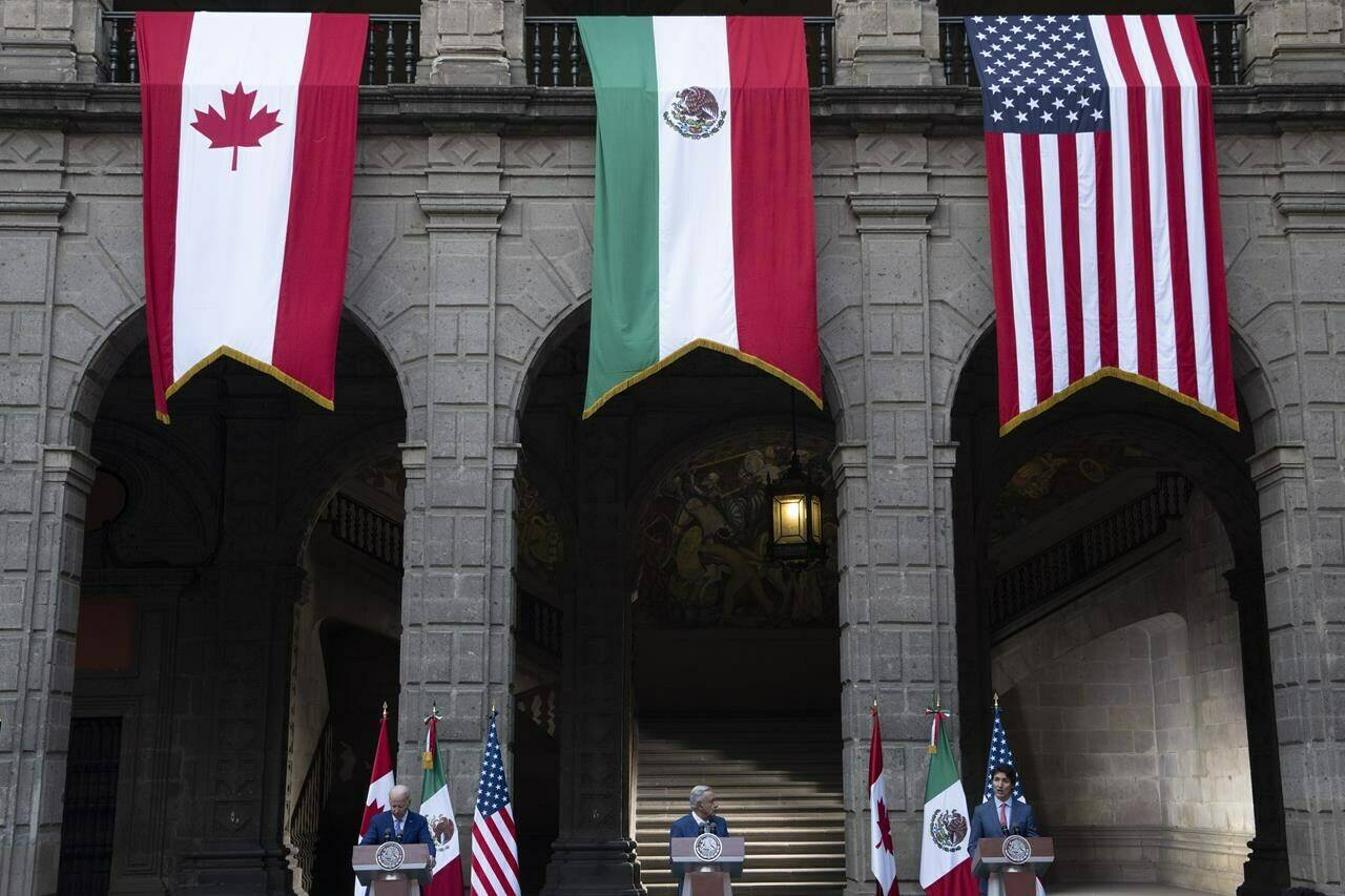 U.S. President Joe Biden and Mexican President Andres Manuel Lopez Obrador listen to Prime Minister Justin Trudeau speak during a joint news conference at the North American Leaders Summit, in Mexico City, Tuesday, Jan. 10, 2023. The Canadian Chamber of Commerce is calling for another NAFTA-style charm offensive to defend Canada’s trade with the U.S. ahead of November’s presidential election. THE CANADIAN PRESS/Adrian Wyld