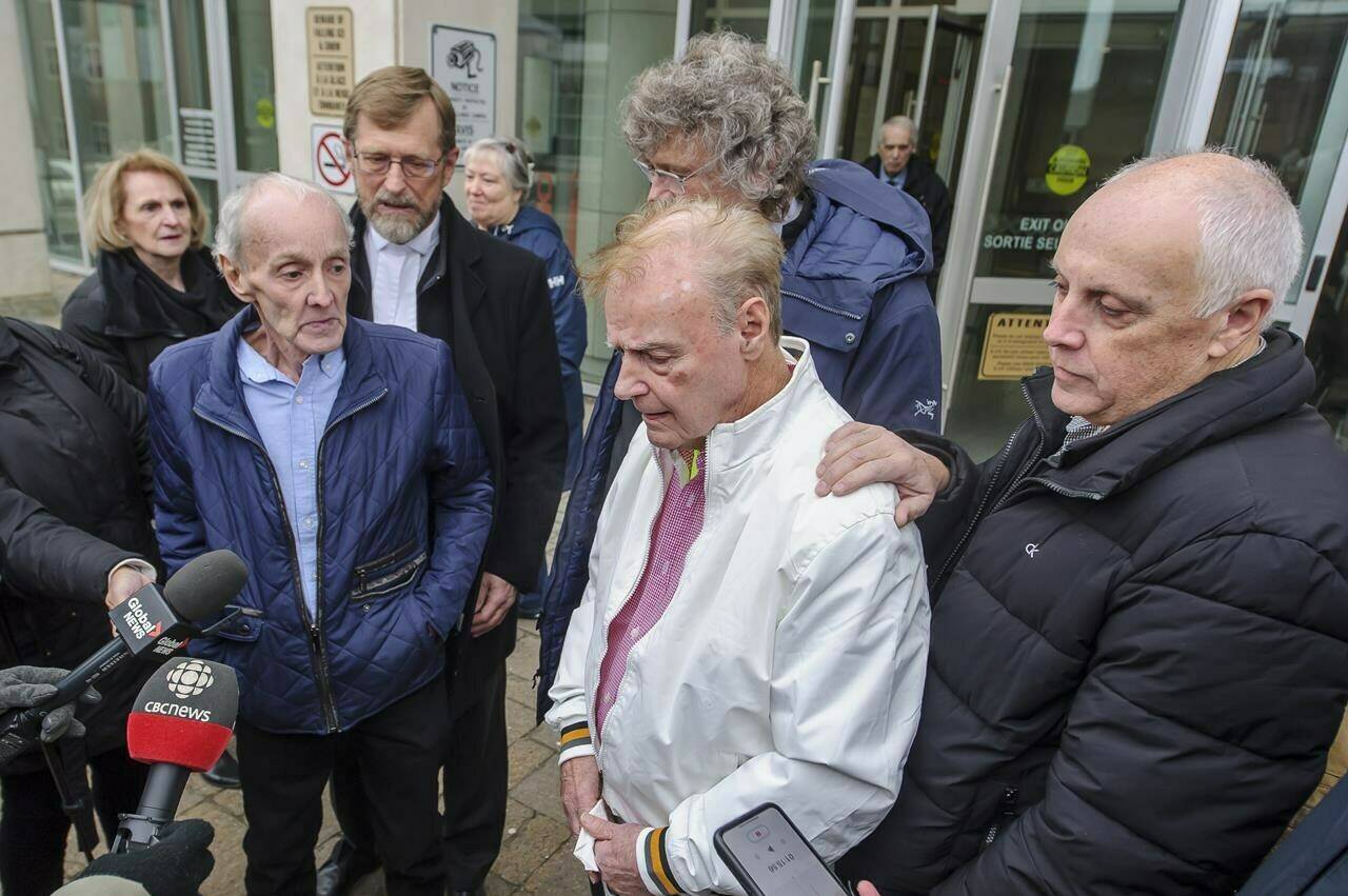Robert Mailman, left, and Walter Gillespie speak to media as Ron Dalton, right, co-president of Innocence Canada, looks on after their hearing at Saint John Law Courts in Saint John, N.B., Jan. 4, 2024. The two men recently had a 1984 murder conviction overturned and have now been found formally not guilty. THE CANADIAN PRESS/Michael Hawkins