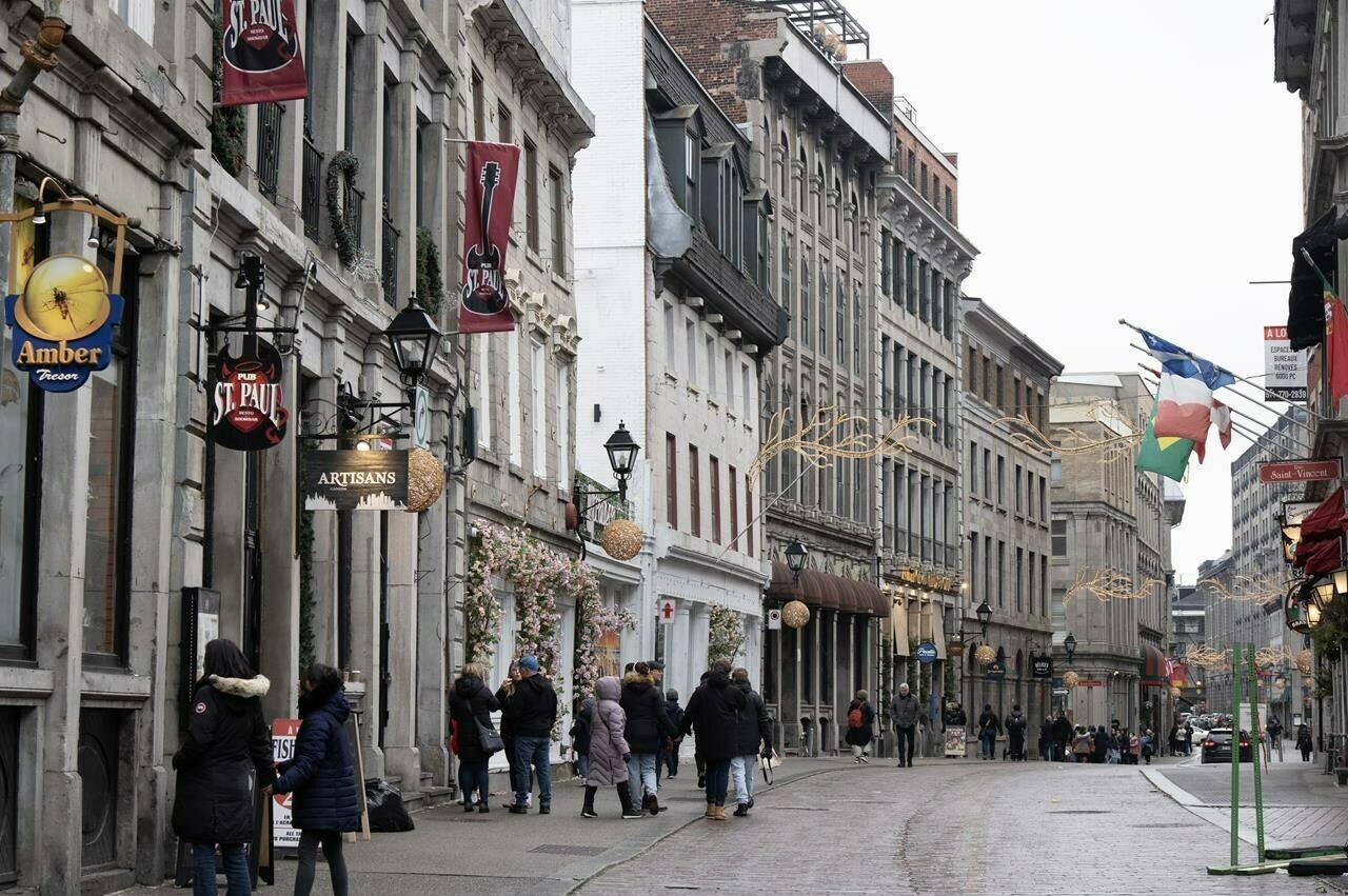 An unusually mild start to winter in Quebec is dampening spirits in a province otherwise known for its vibrant winter culture. People walk on the snowless streets in Old Montreal, Wednesday, Jan. 3, 2024. THE CANADIAN PRESS/Ryan Remiorz