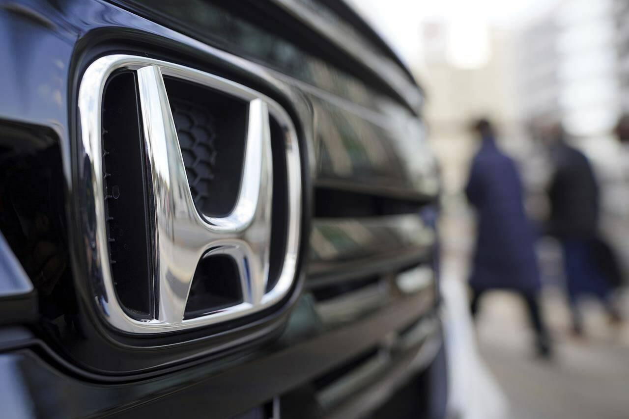 A Japanese news outlet is reporting that Honda Motor Co. Ltd. could invest upwards of $18.4 billion in an electric vehicle plant in Canada. People walk near the logo of Honda Motor Company at a showroom in Tokyo, Feb. 8, 2022. THE CANADIAN PRESS/AP-Eugene Hoshiko