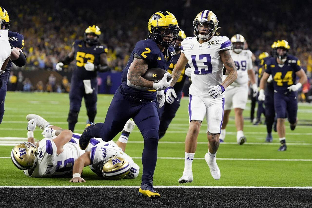 Michigan running back Blake Corum scores against Washington during the second half of the national championship NCAA College Football Playoff game Monday, Jan. 8, 2024, in Houston. (AP Photo/David J. Phillip)