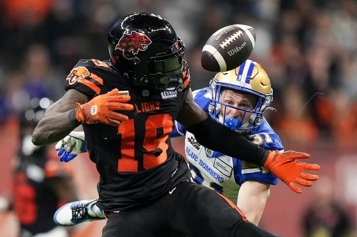 B.C. Lions’ Dominique Rhymes makes a reception as Winnipeg Blue Bombers’ Evan Holm defends during the second half of a CFL football game, in Vancouver, on Friday, October 6, 2023. It appears Rhymes’ time with the B.C. Lions has come to an end. According to a CFL source, the Lions and veteran receiver have mutually agreed to part ways.THE CANADIAN PRESS/Darryl Dyck