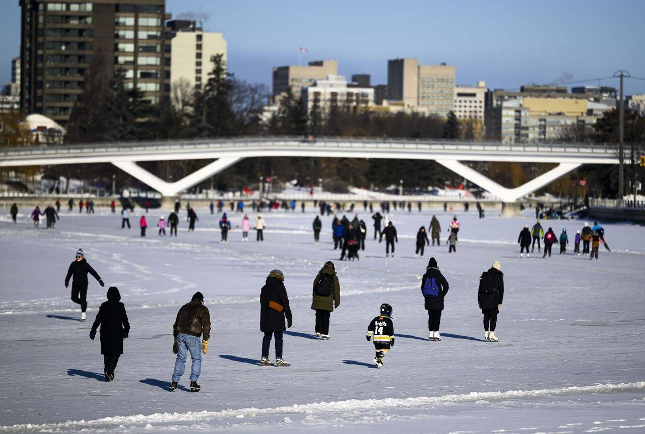 People skate on the Rideau Canal Skateway on its opening day in Ottawa, on Sunday, Jan. 21, 2024. Skaters flocked to the ice, one year after warm and wet weather prevented the 7.8 kilometre skateway from opening for its 2023 season. THE CANADIAN PRESS/Justin Tang